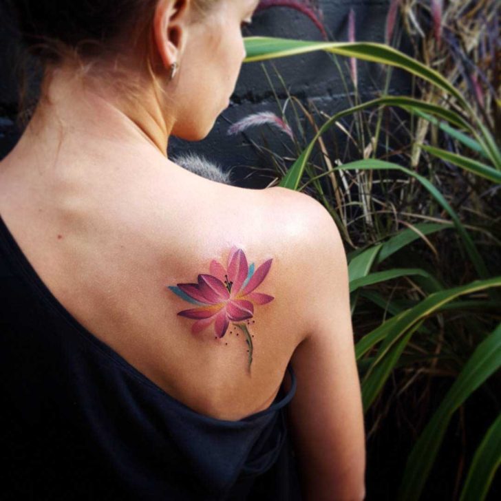 Purple lotus tattoo on the shoulder blade