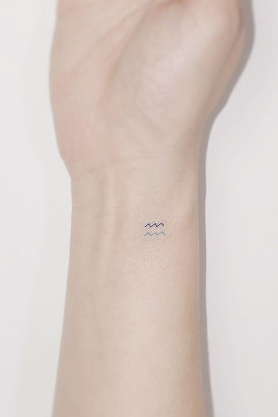 Small Aquarius symbol tattooed on the wrist