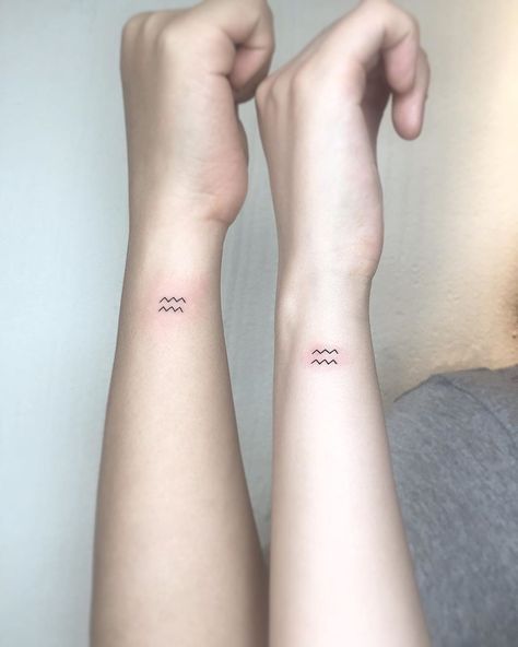 Paired tattoo of the sign of Aquarius