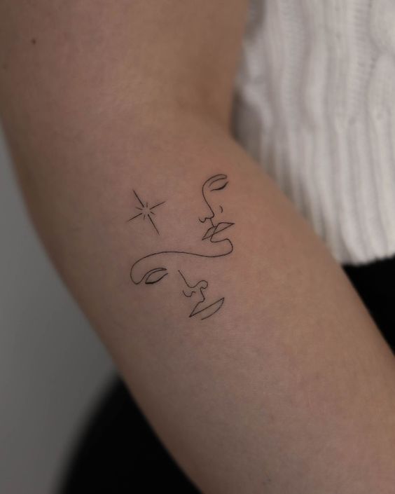 Tattoo sign of the zodiac Gemini in the style of minimalism on the arm