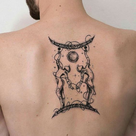 Cool tattoo of the zodiac sign Gemini on the back