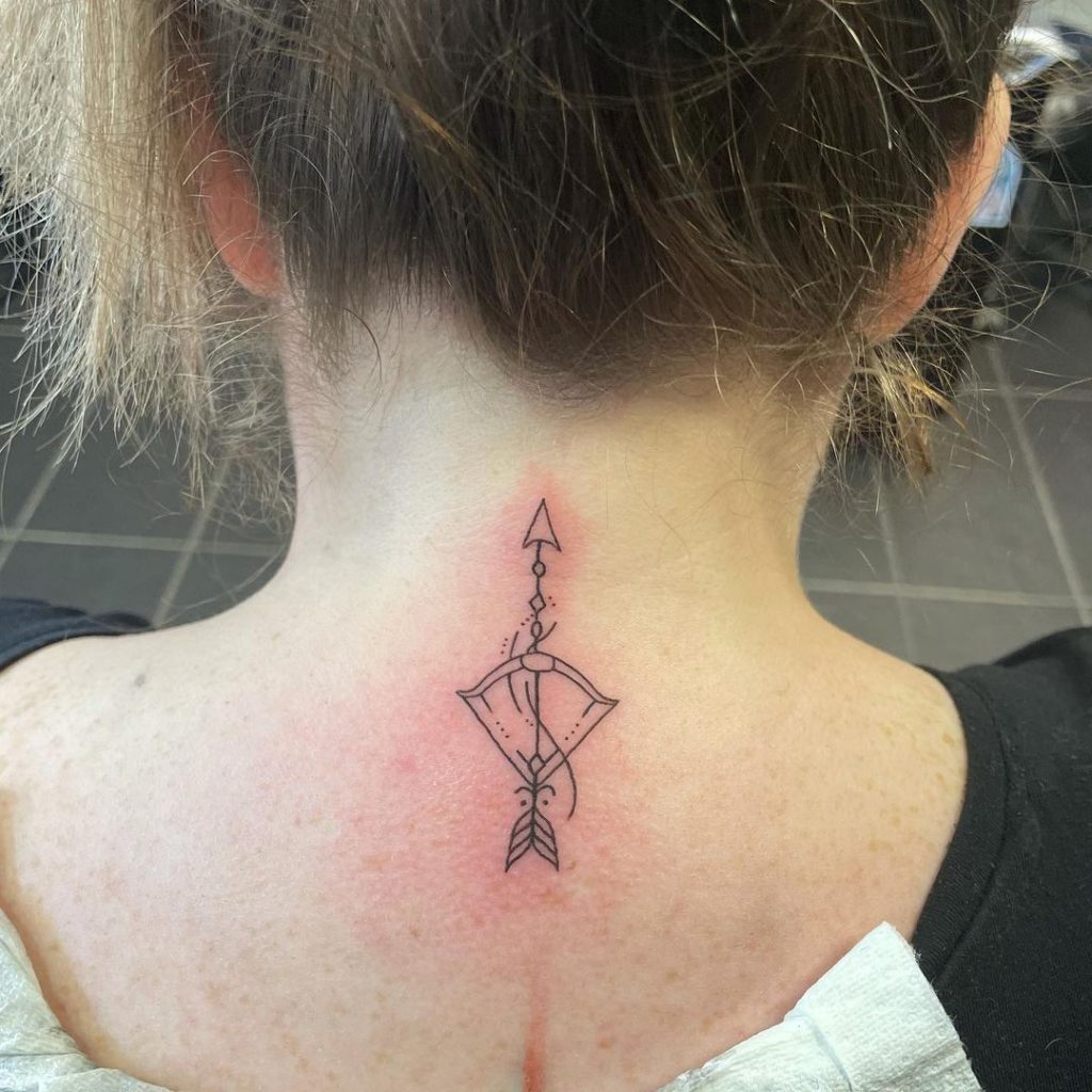 Tattoo of the zodiac sign Sagittarius on the arm on the neck