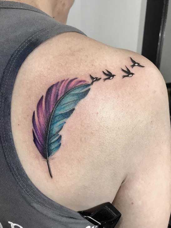 Feather tattoo on shoulder blade