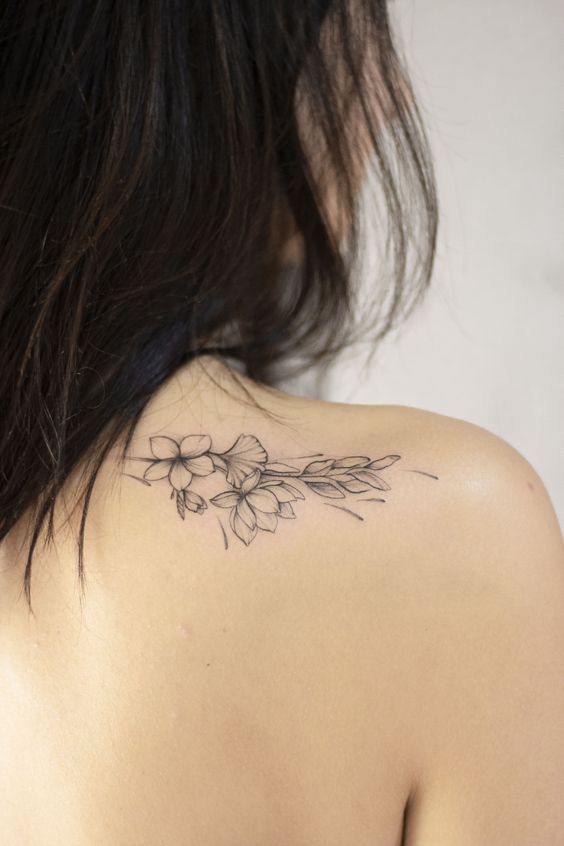 Flower tattoo on shoulder blade