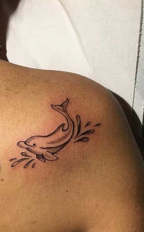 Dolphin tattoo on the shoulder blade