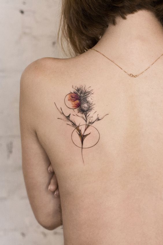 A small tattoo on the shoulder blade