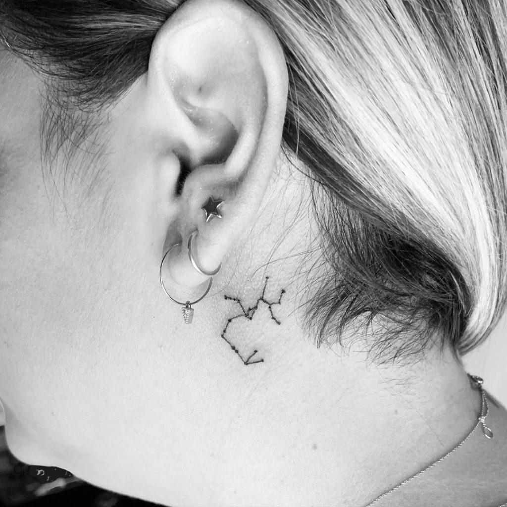 Tattoo constellation of the zodiac sign Sagittarius behind the ear