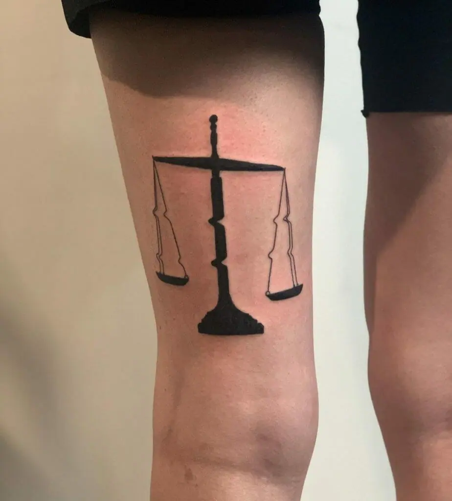 Libra zodiac sign tattoo on the leg