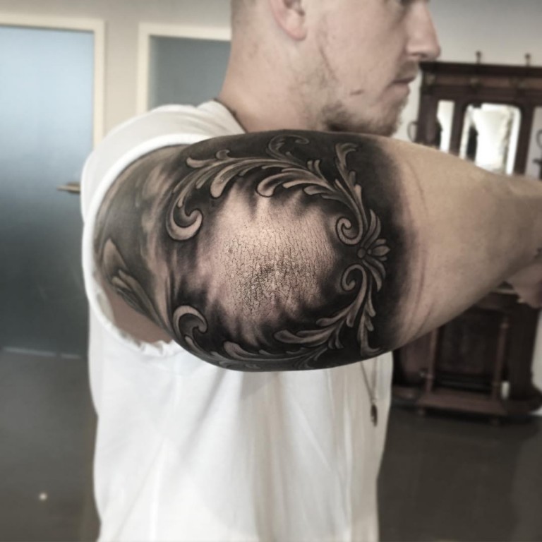 Black and gray tattoo on the elbow