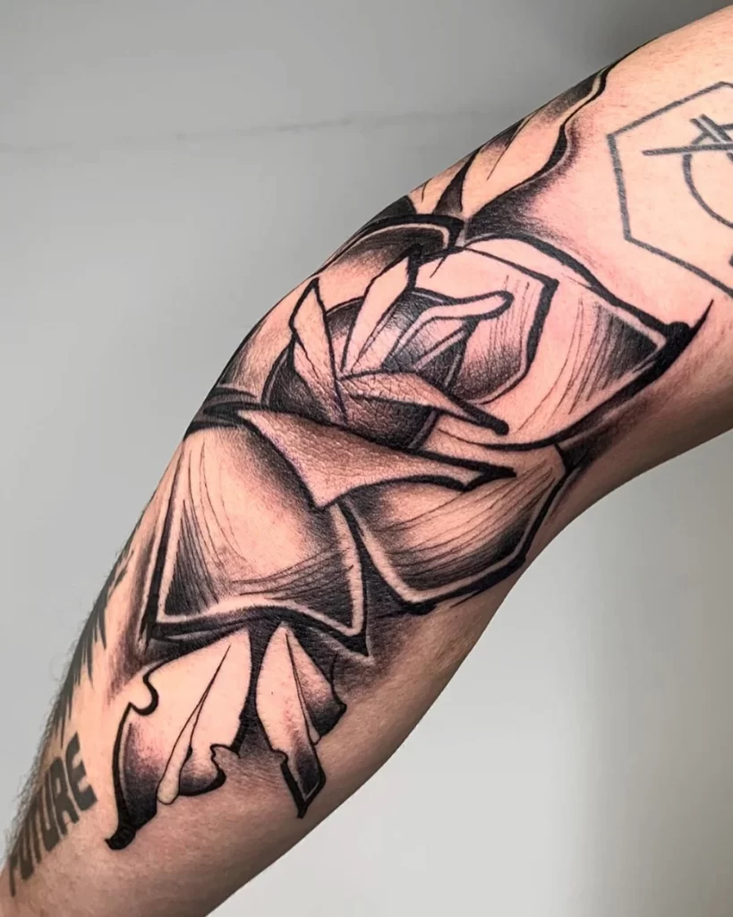 Flower tattoo on the elbow with black ink