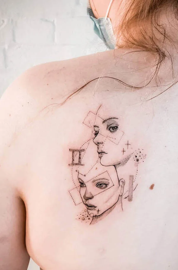 Beautiful tattoo of twins on the shoulder blade