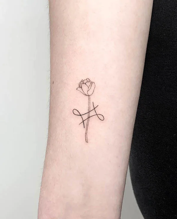 Tattoo of a rose and the symbol of the zodiac sign Gemini on the wrist