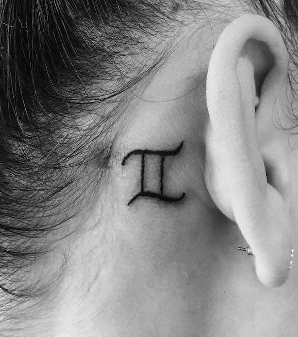 Tattoo of Gemini behind the ear