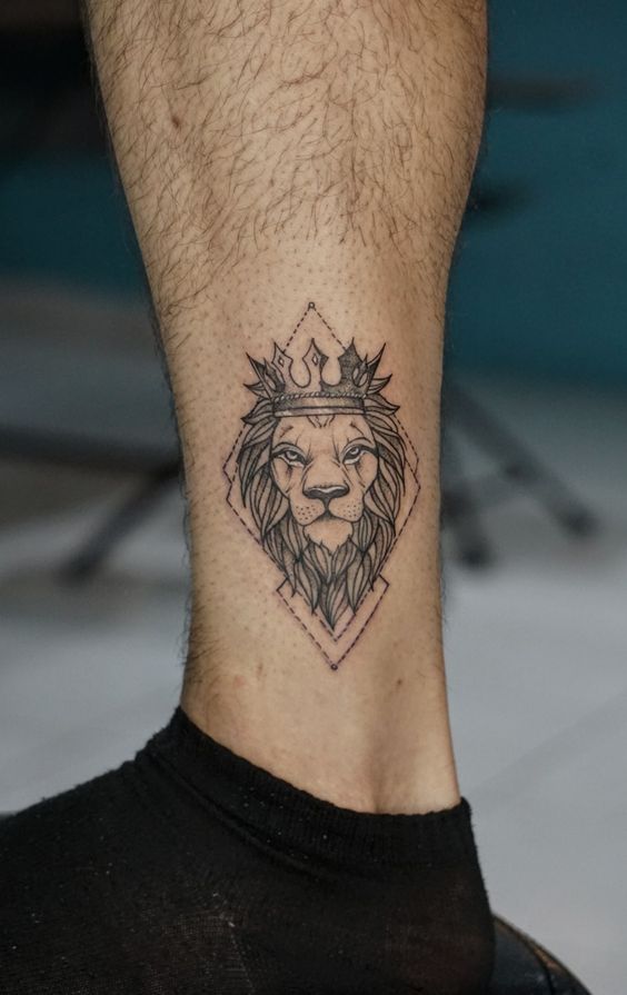 Tattoo of the zodiac sign lion on the shin for men