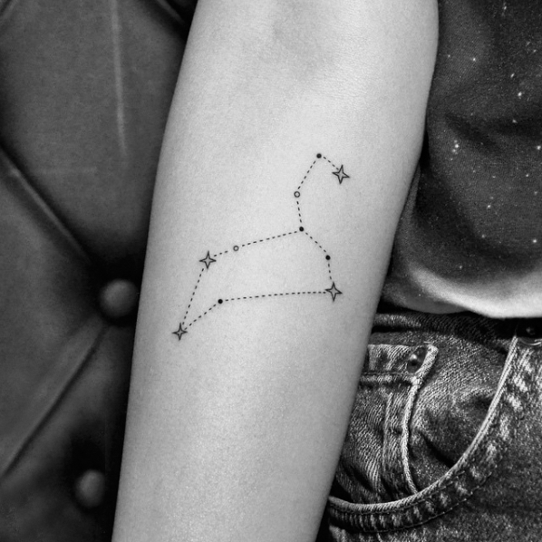 Tattoo of the constellation zodiac sign lion on the forearm for women