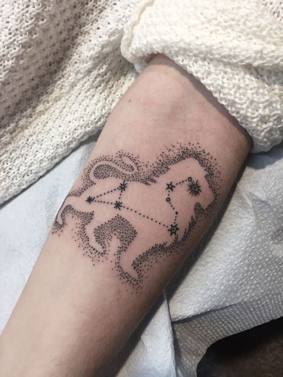 Tattoo of the constellation zodiac sign lion on the forearm for women