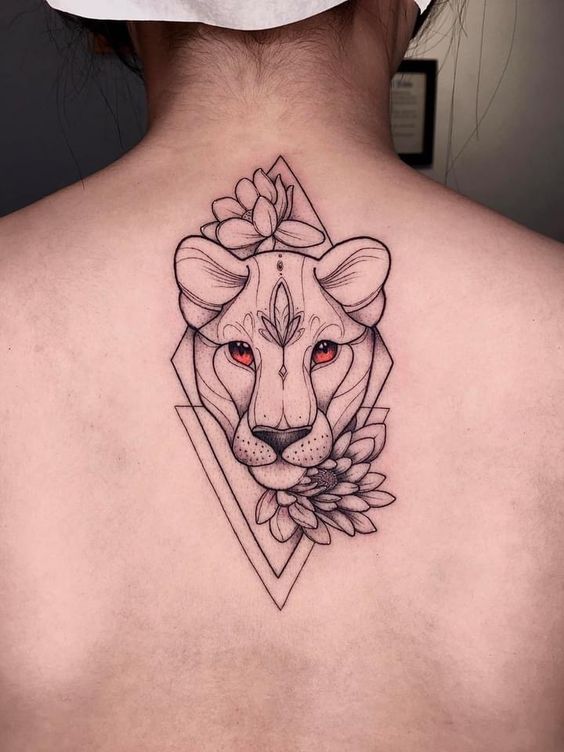 Tattoo of the zodiac sign lion on the back for women