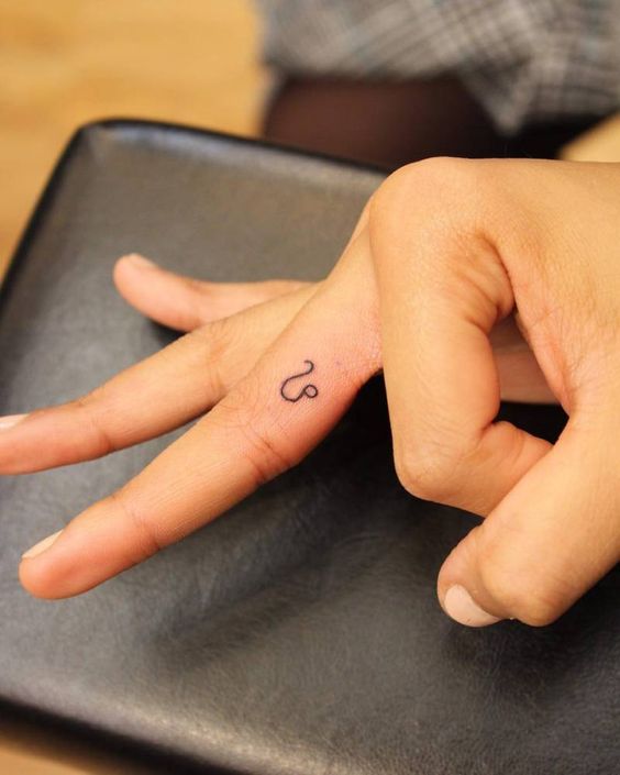 Tattoo symbol of the zodiac sign lion on the finger for men