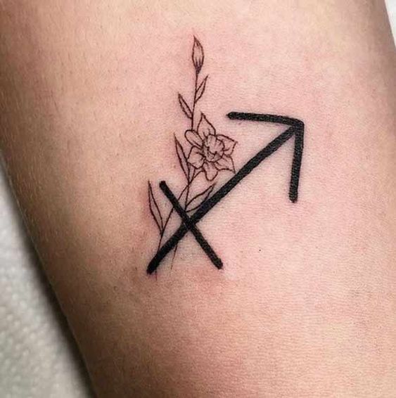 Tattoo of the zodiac sign Sagittarius on the leg for women