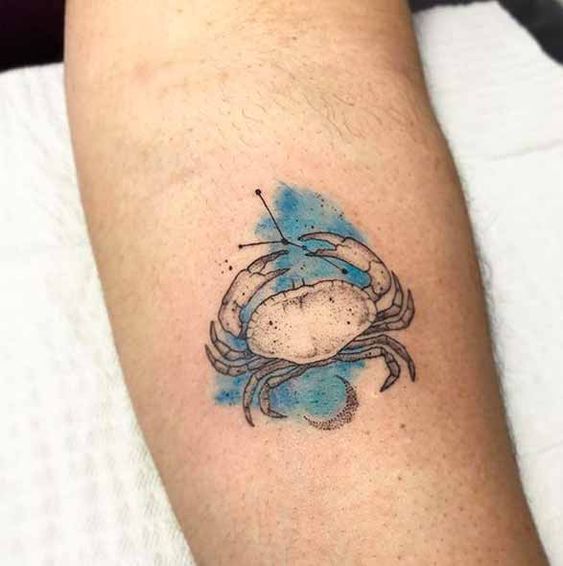 Tattoo of the zodiac sign Cancer on the forearm for men