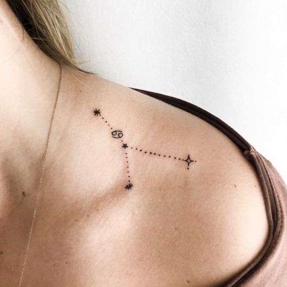 Tattoo of the zodiac sign of Cancer on the collarbone for women