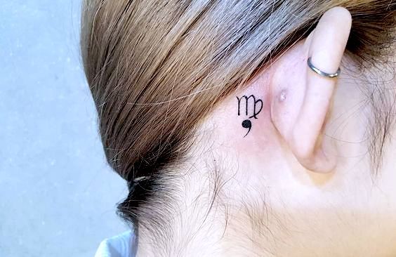 Tattoo symbol of the zodiac sign Virgo on the neck for women