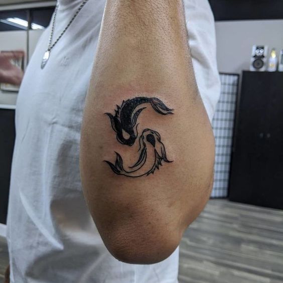 Tattoo of the zodiac sign of a fish on the forearm for men