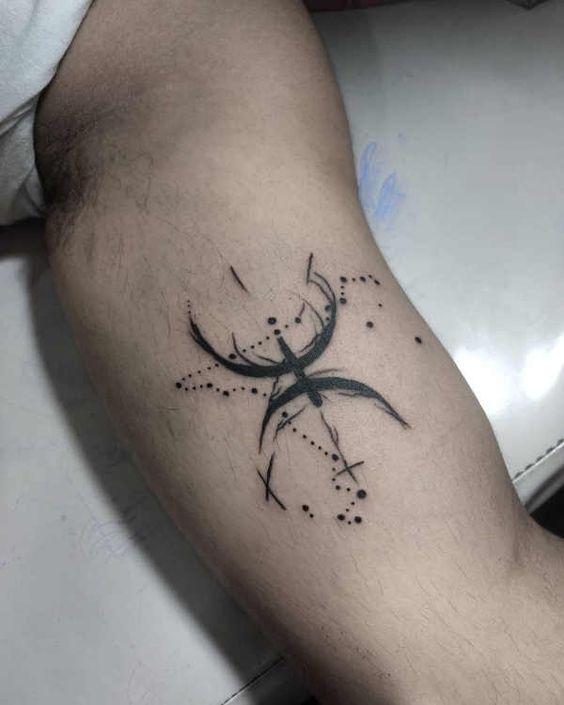 Tattoo symbol of the zodiac sign of fish on the bicep for men