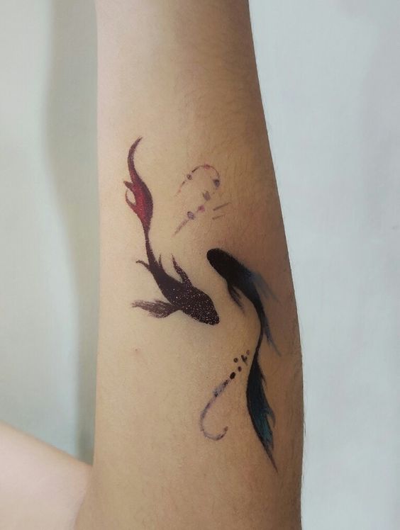 Tattoo of the zodiac sign of a fish on the forearm for men