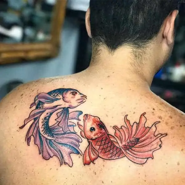 Tattoo of the zodiac sign fish on the back for men