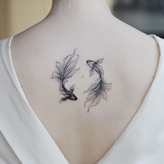 fish zodiac sign tattoo on the back for women