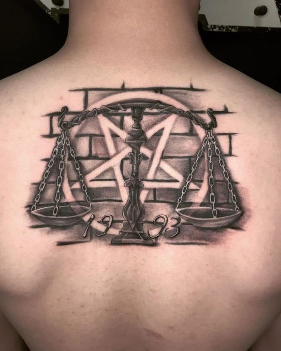 Tattoo of the zodiac sign Libra on the back for men