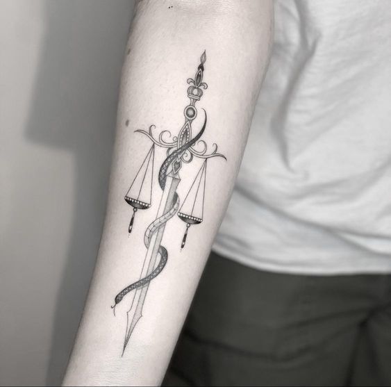 Tattoo of the zodiac sign Libra on the forearm for men