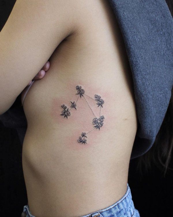 Tattoo the constellation sign of the zodiac Libra on the side for women