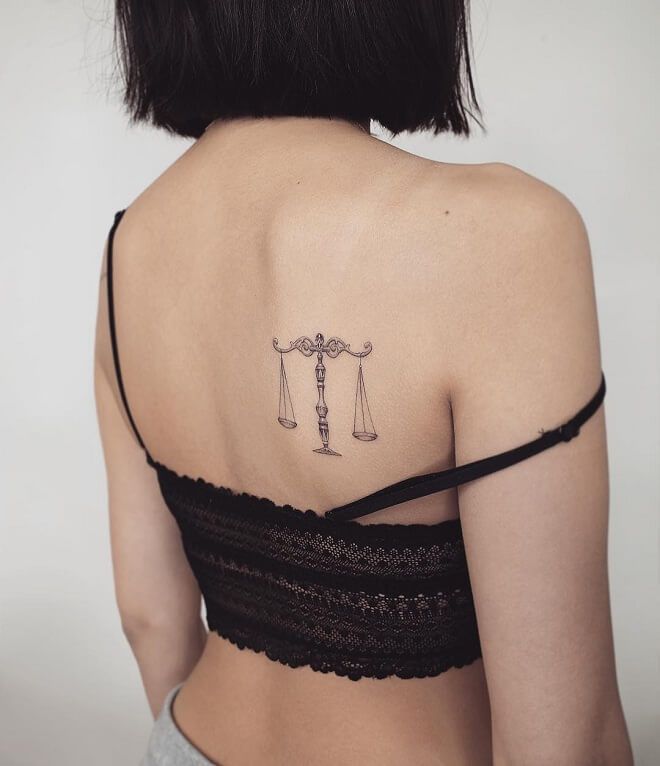 Tattoo of the zodiac sign Libra on the shoulder blade for women