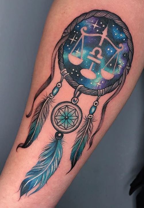 Tattoo of the zodiac sign Libra on the forearm