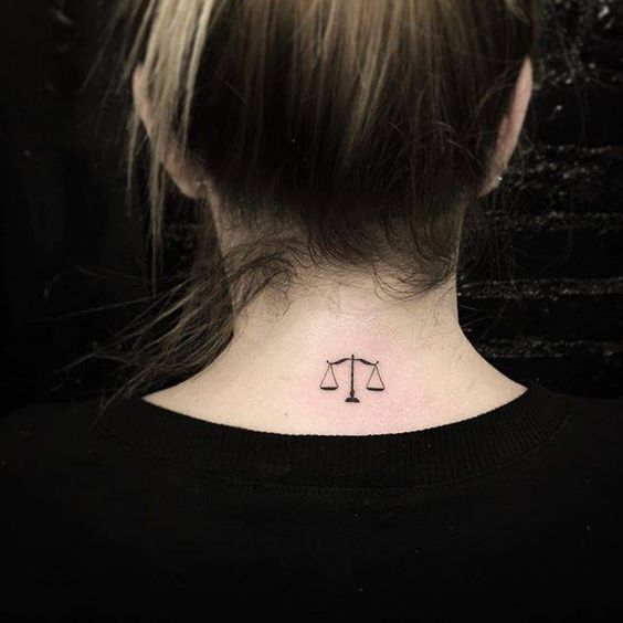 Tattoo of the zodiac sign Libra on the back of the head for women