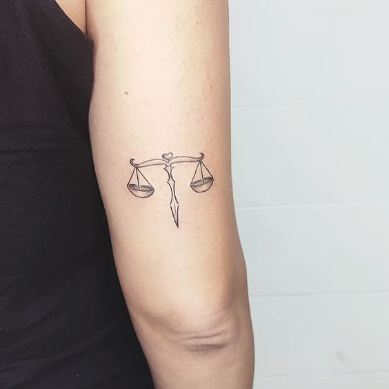 Tattoo of the zodiac sign Libra on the shoulder for women