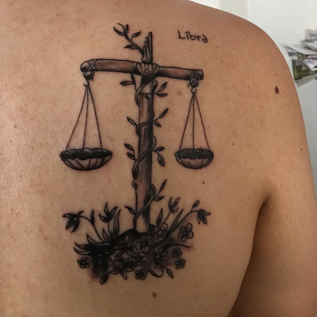 Tattoo of the zodiac sign Libra on the shoulder blade for men