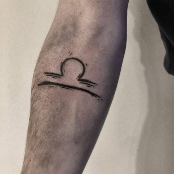 Tattoo of the zodiac symbol Libra on the forearm for men