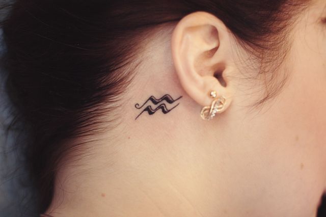 Tattoo of the zodiac sign Aquarius on the neck for women