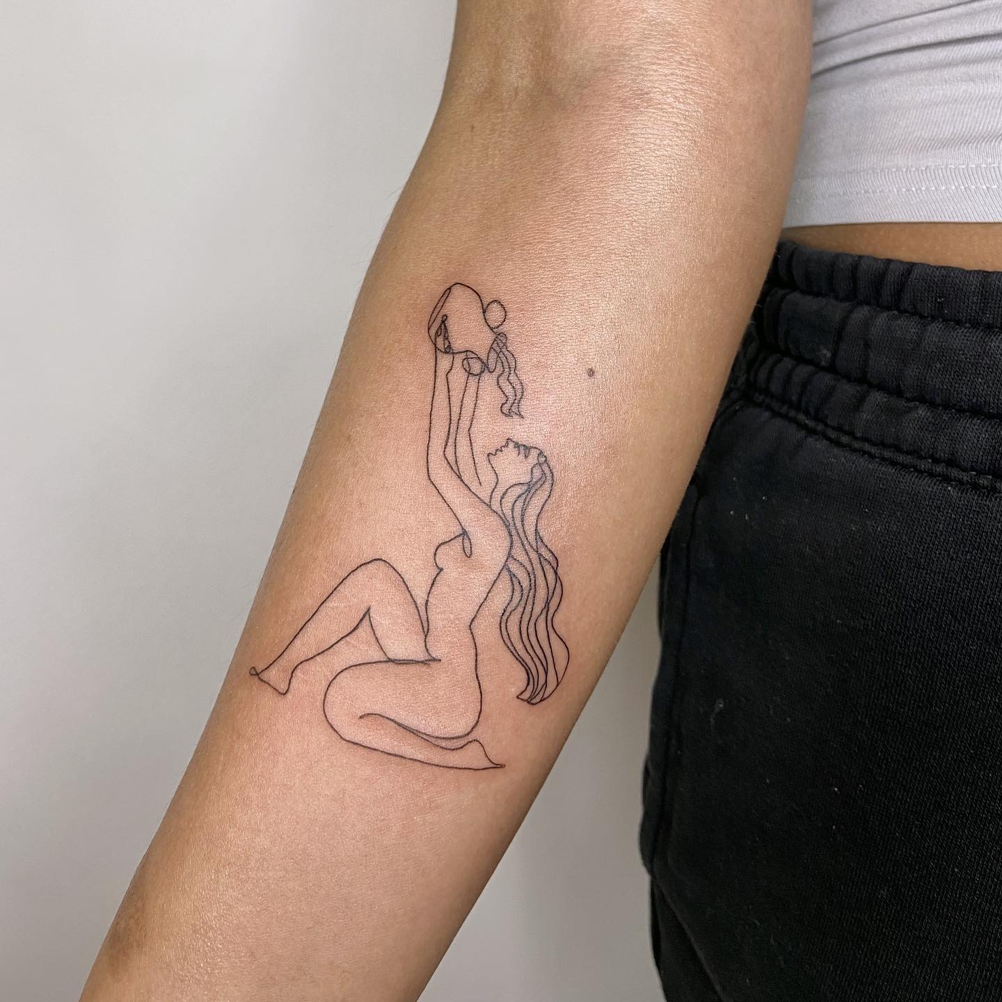 Aquarius zodiac sign tattoo on forearm for women