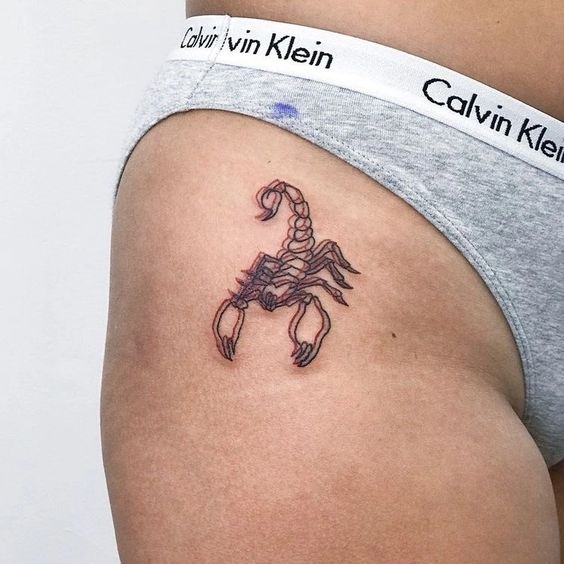 Tattoo of the zodiac sign of the scorpion on the hip for women