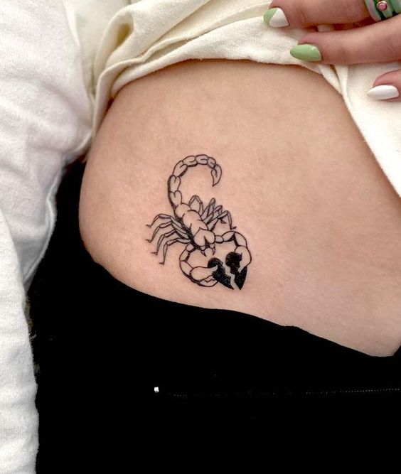 Tattoo of the zodiac sign of the scorpion on the stomach for women