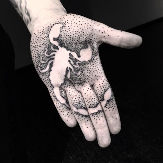 Tattoo of the zodiac sign of a scorpion on the palm of the hand for men