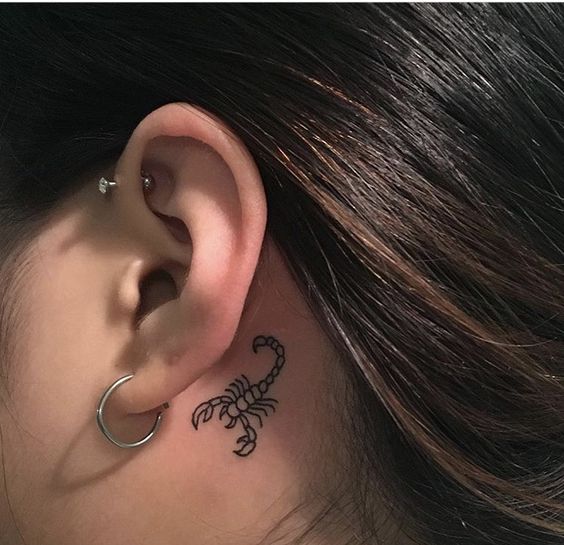 Tattoo of the zodiac sign of a scorpion on the neck for women