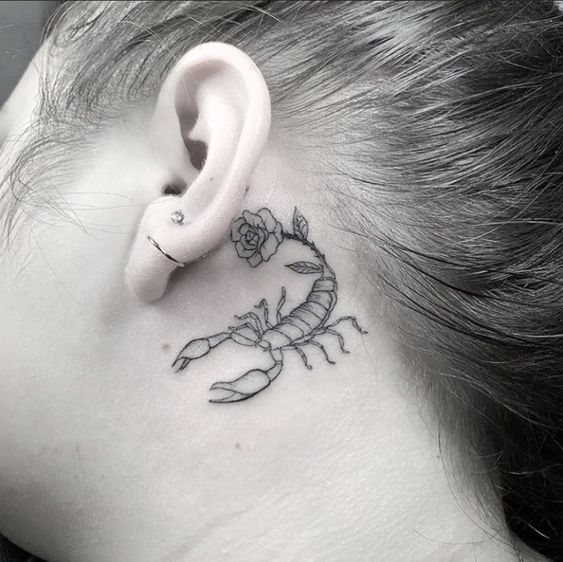 Tattoo of the zodiac sign of a scorpion on the neck for women