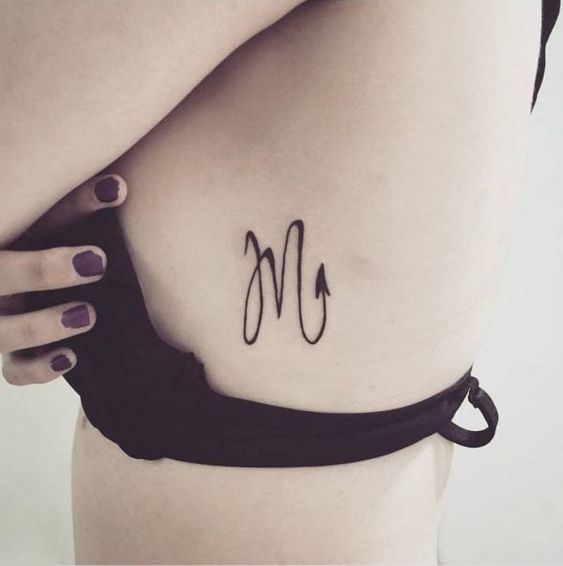 Tattoo of the zodiac sign scorpion on the side for women