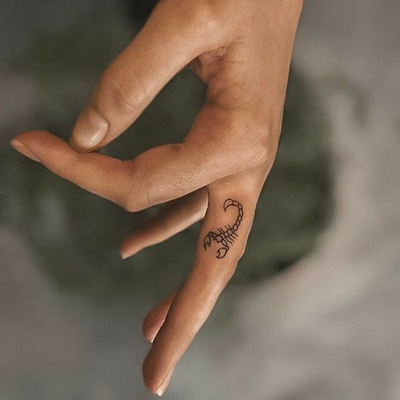 Tattoo of the zodiac sign of a scorpion on the finger for men