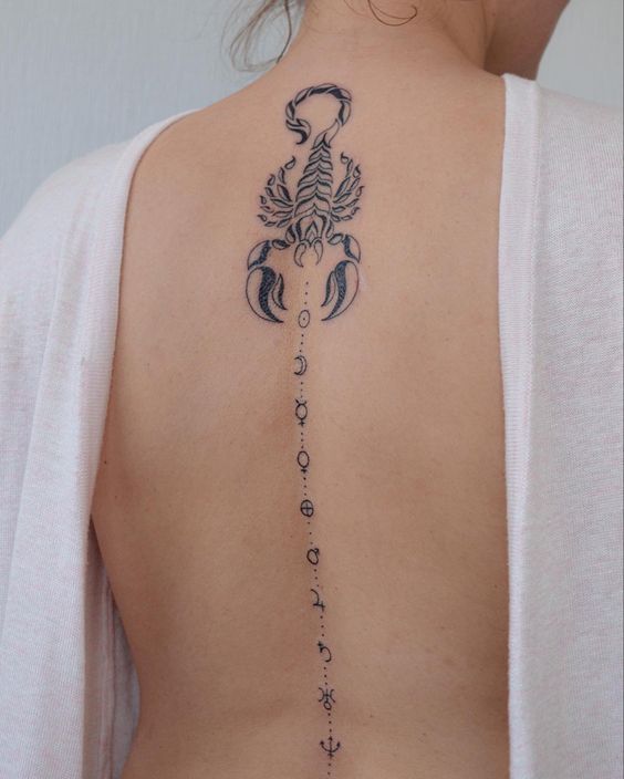 Tattoo of the zodiac sign of a scorpion on the spine for women